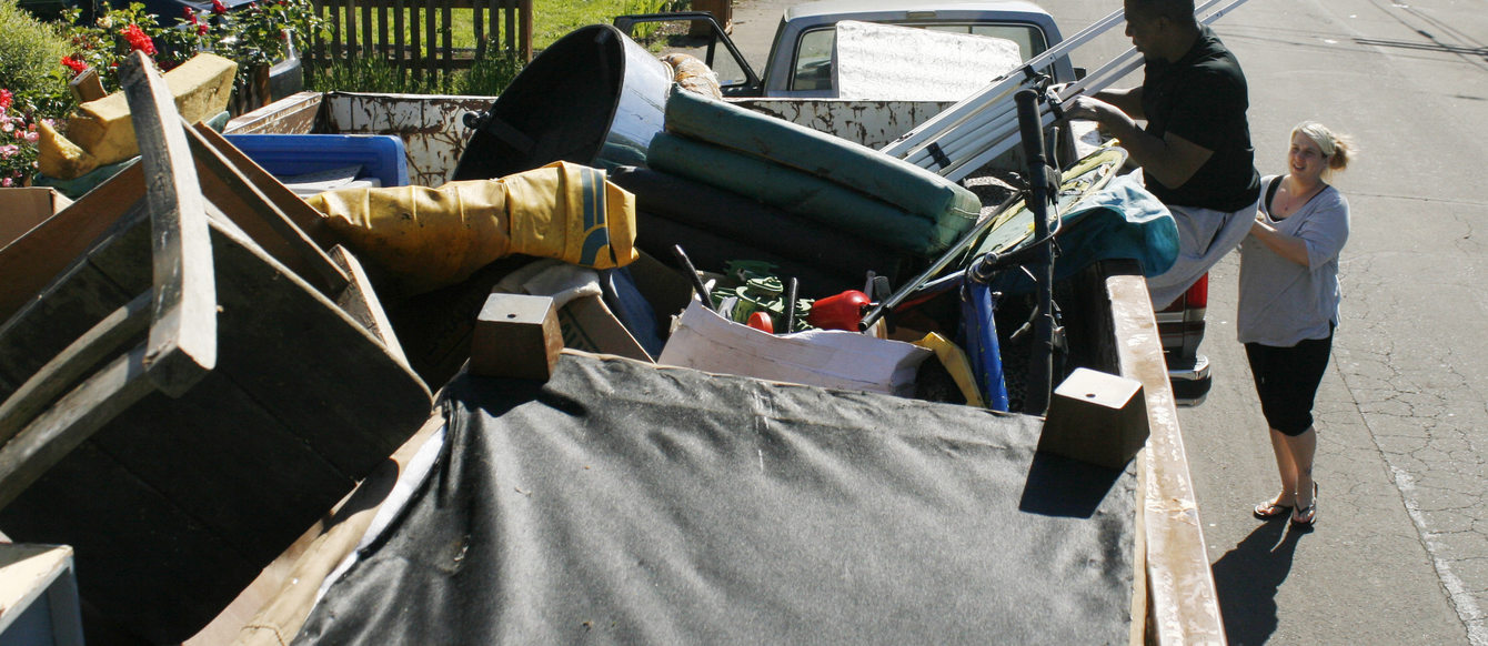 Ron and Sabrina Lincoln load their unwanted items into a drop box on SE Ellis Street.