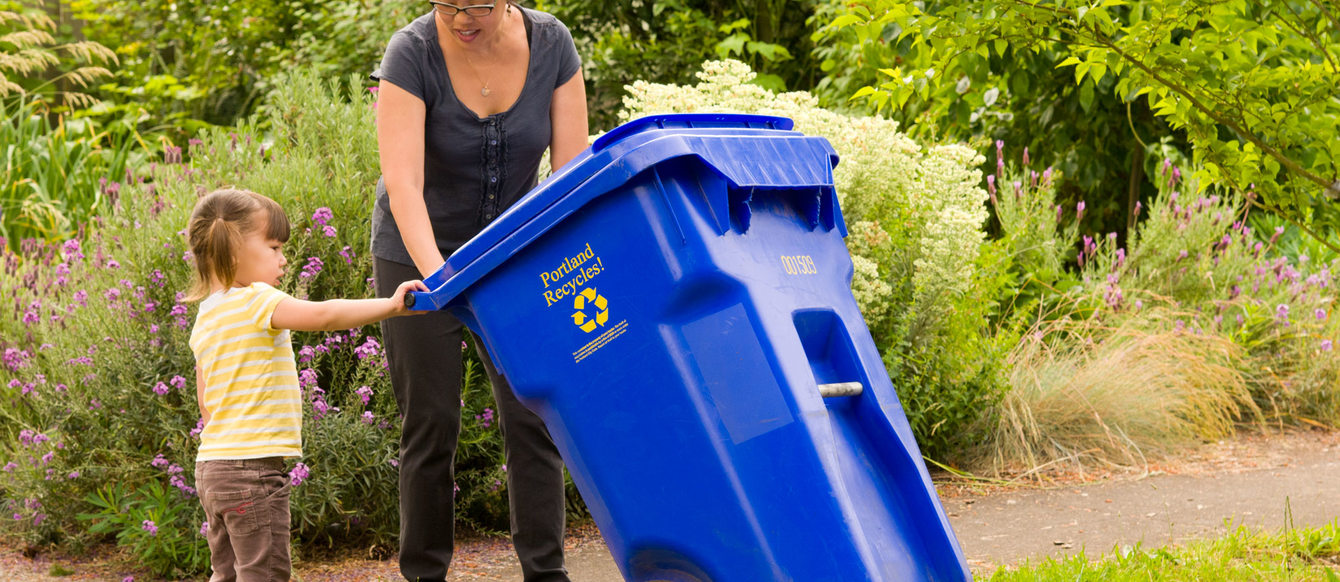 Image of mom and child with recycling bin