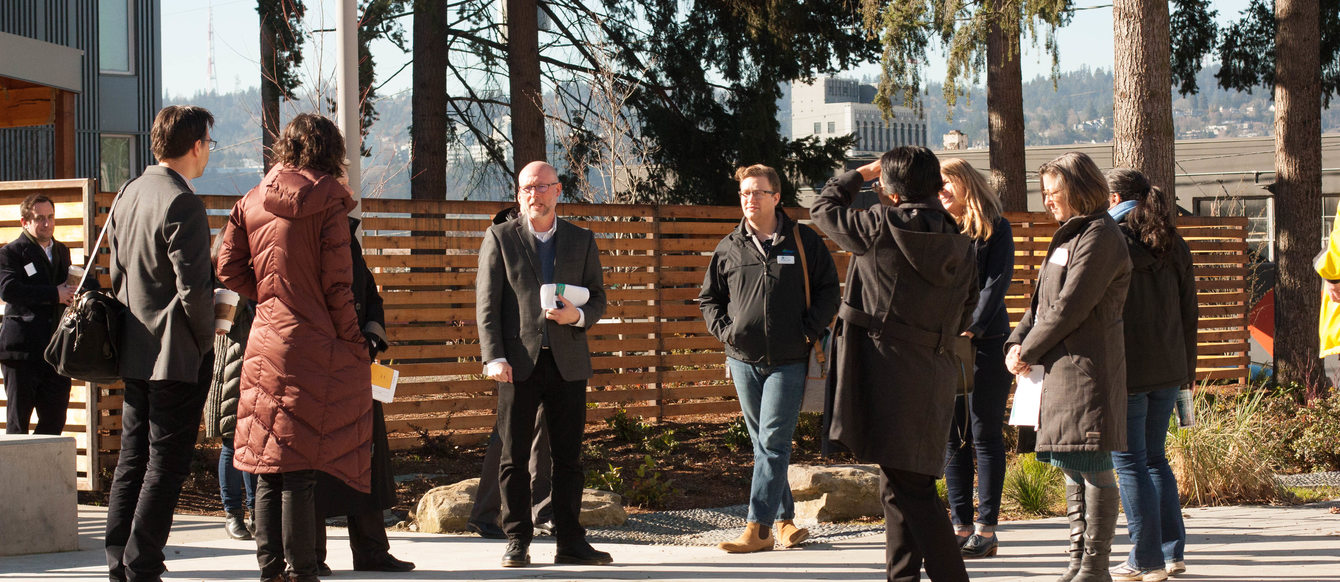 People speaking at the St Francis Park apartments in Portland