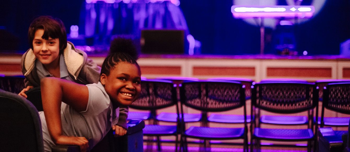 Two children pose in the Keller Auditorium