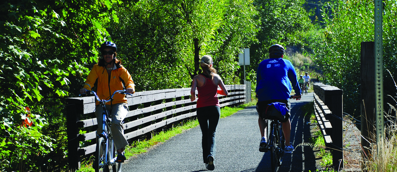 People walking and biking on a trail