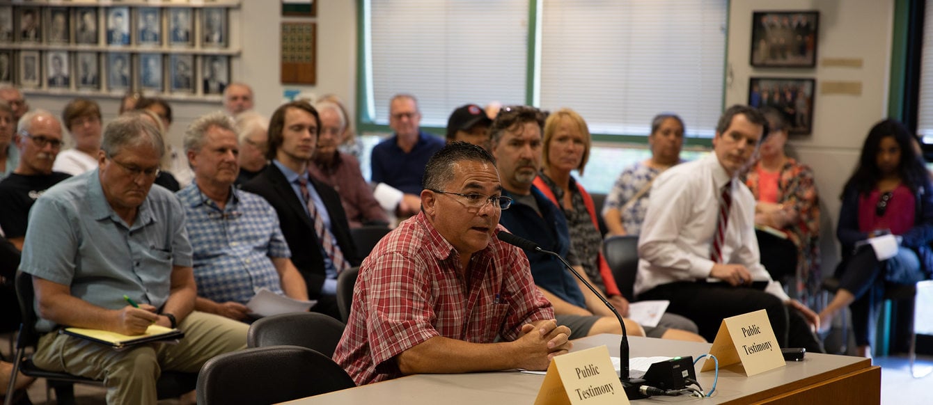 A man gives testimony about the Southwest Corridor plan at a meeting in Tigard