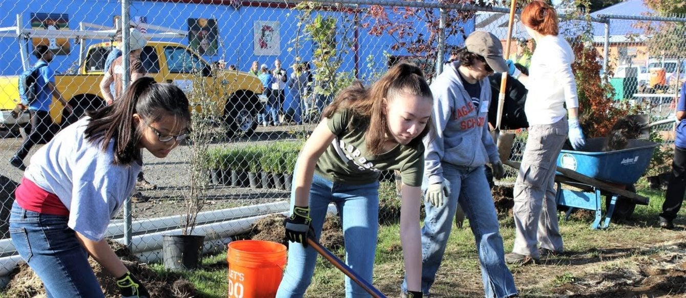 photo of children planting trees at M&M Marketplace