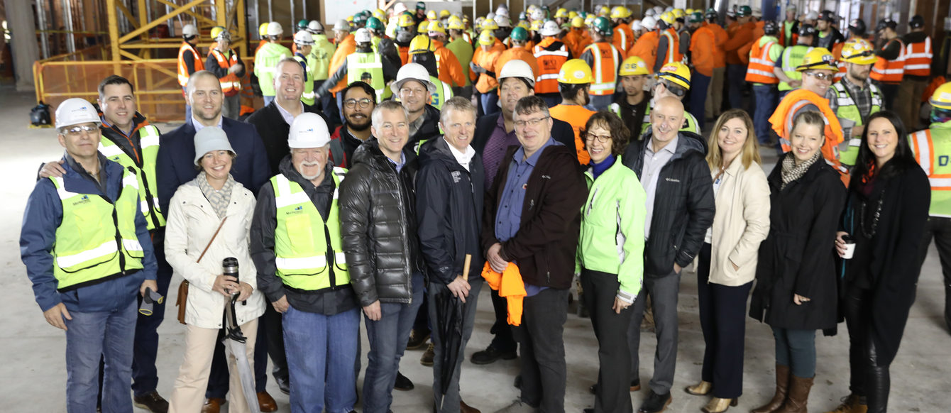 Metro staff and councilors gather with construction crew for a group photo to celebrate the topping off of the Hyatt Regency Portland hotel project
