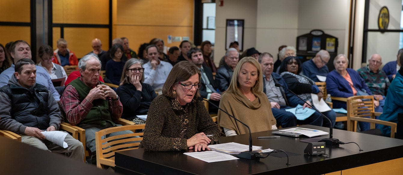 A woman speaks at a public hearing at the Metro Council