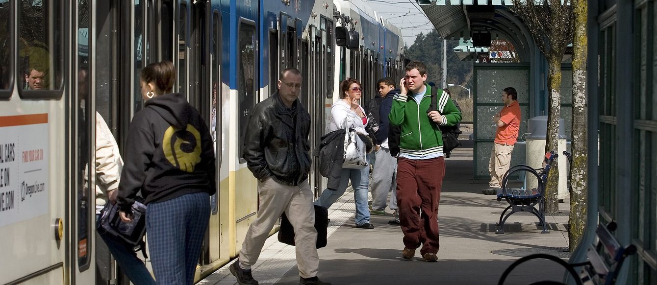 riders entering and exiting a MAX light rail train