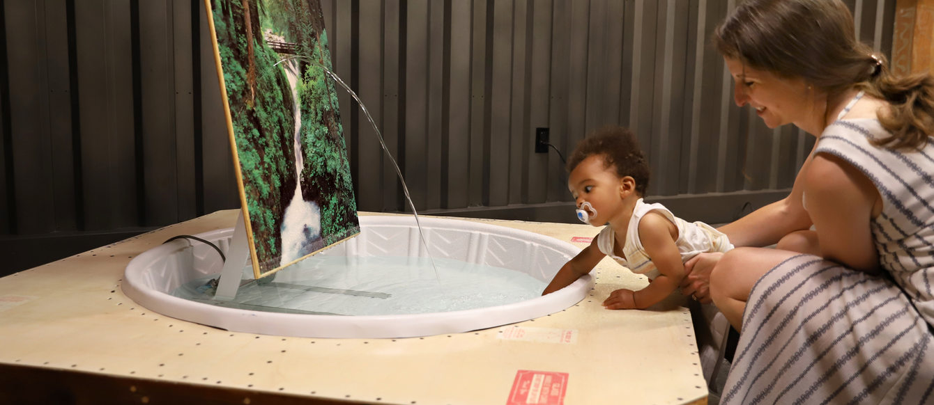 woman and infant explore a culture at GLEAN 2019