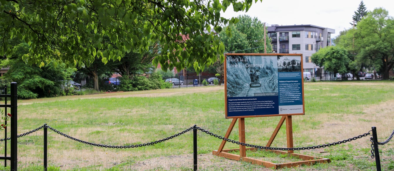 A sign on Block 14 lot at Lone Fir Cemetery, under trees