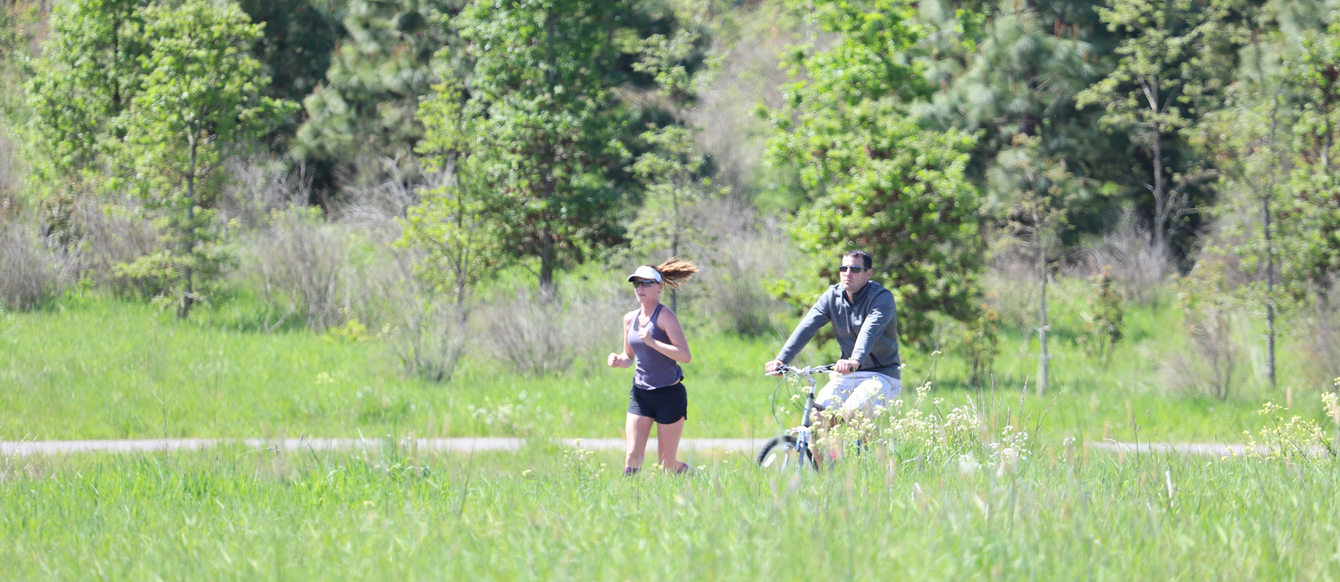 People walking and cycling on a trail at Graham Oaks Nature Park