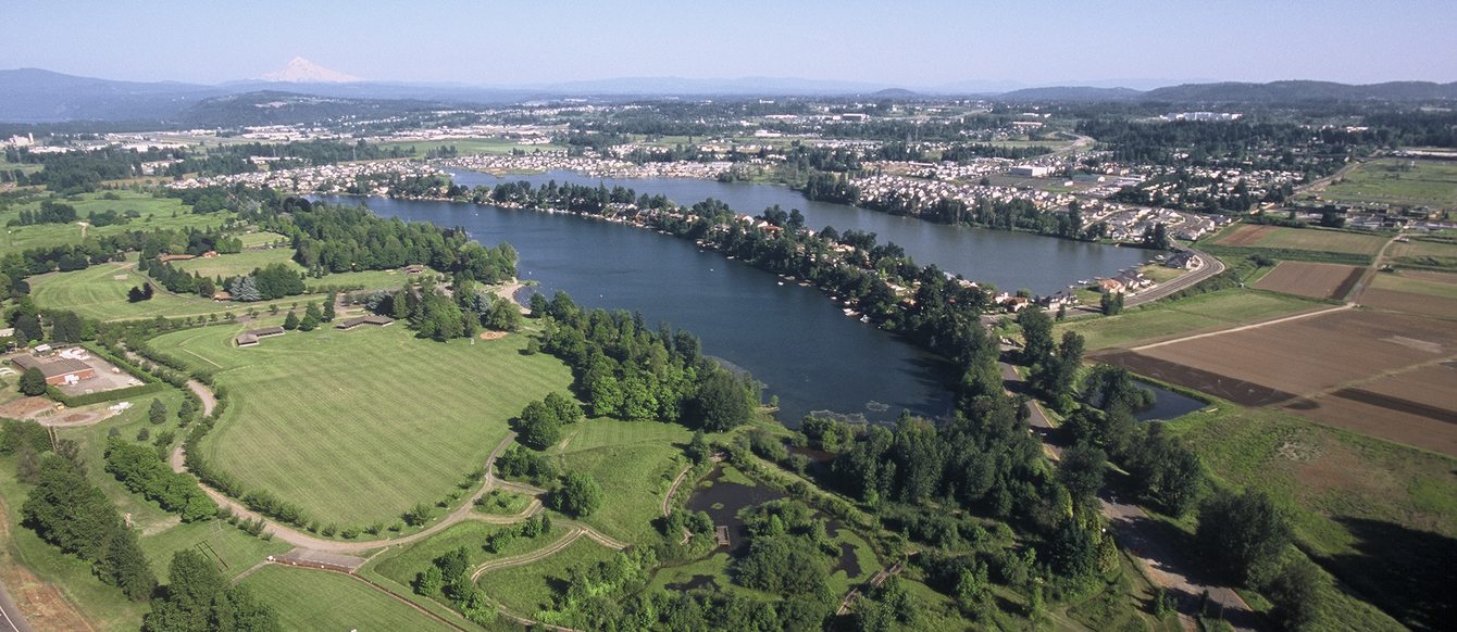 Aerial photo of Blue Lake Park, surrounded by green trees and houses