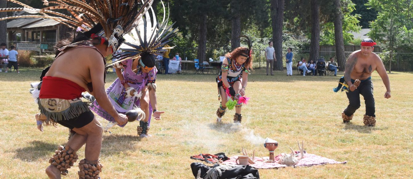 Four people dancing at the Mayan Culture and Tradition Festival