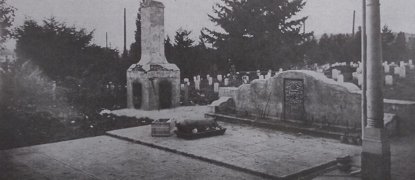old monochrome photo of Chinese cemetery with a roast pig presented at an altar as an offering and a funerary burner to the side of the altar