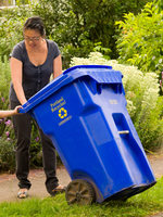 Image of mom and child with recycling bin