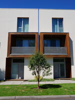 A street-side view of a row of modern-looking condos. 