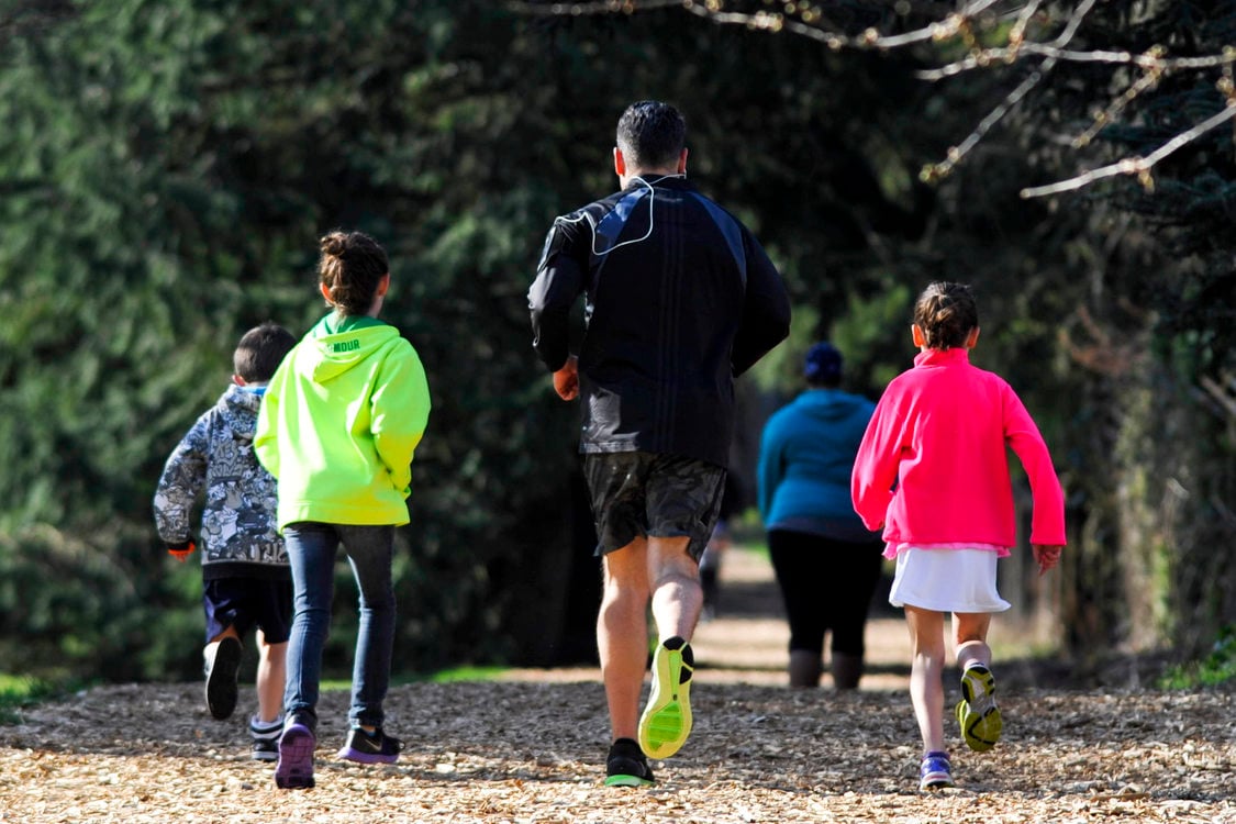 photo of a family running on the fitness trail