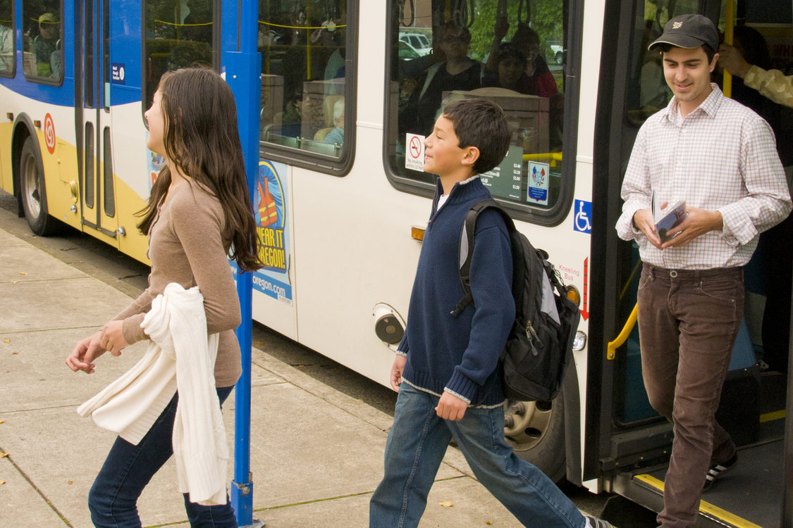 photo of family getting off a bus