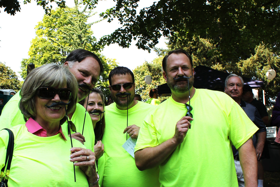 Bottler family members wear fake mustaches