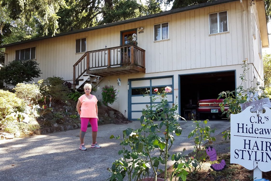 Carole Rovig in front of her house