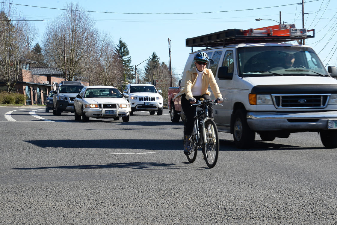 Woman biking with traffic