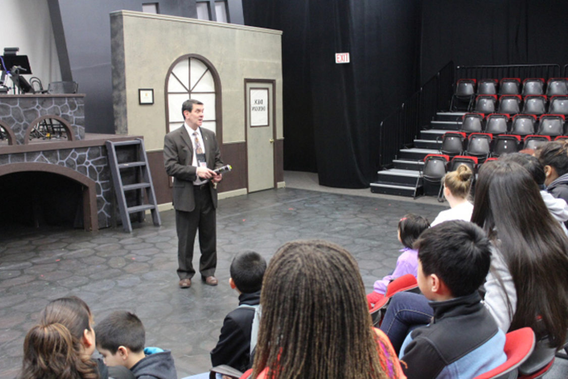 Event services manager Joe Durr shares stories of different theater opportunities with Marathon Scholars in Brunish Theatre in the Portland'5 Centers for the Arts.