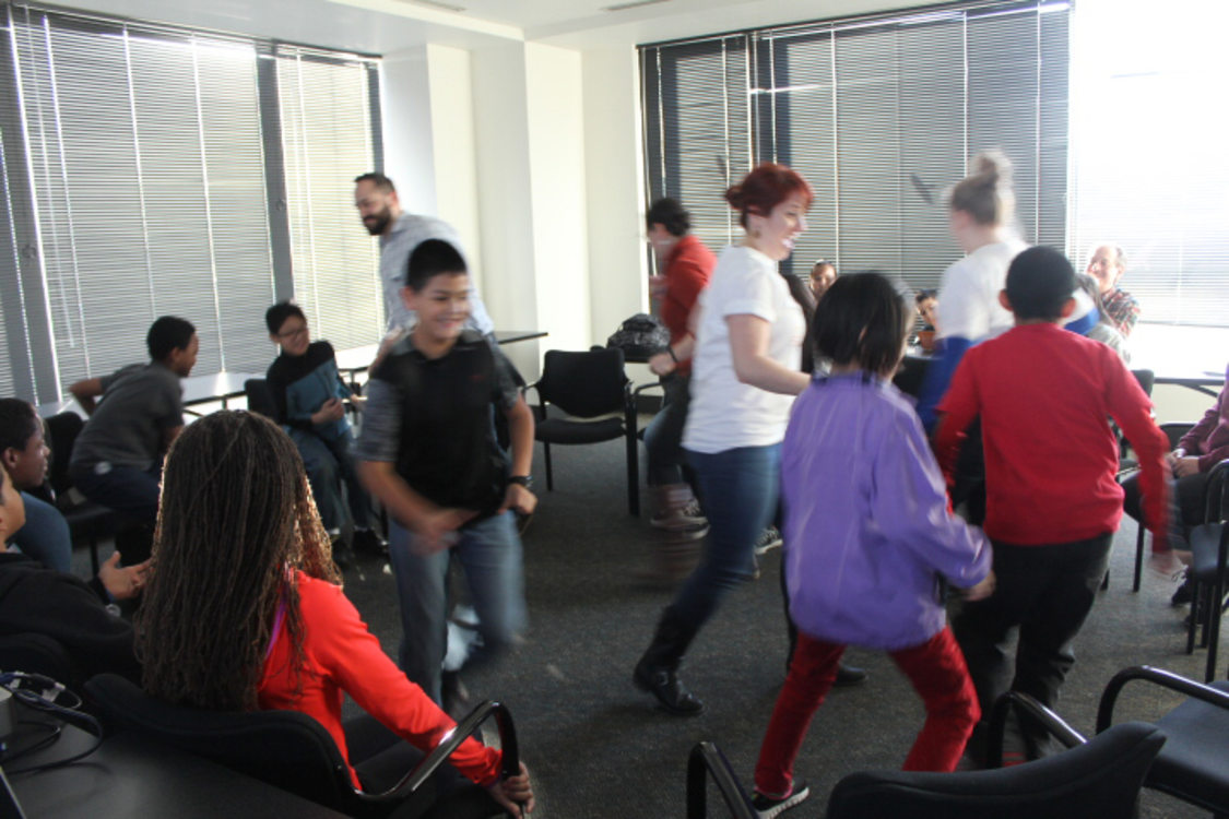 Students and staff run around in a sustainability themed game led by Kimberly Taylor.