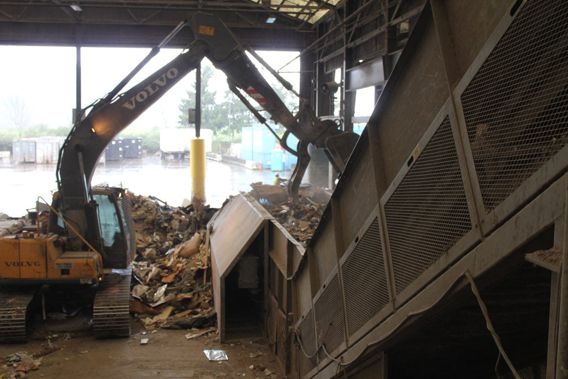 Dry waste from Bay 1 is dropped onto a ramping conveyor belt, to lift to workers who will pull out anything that can be recycled.