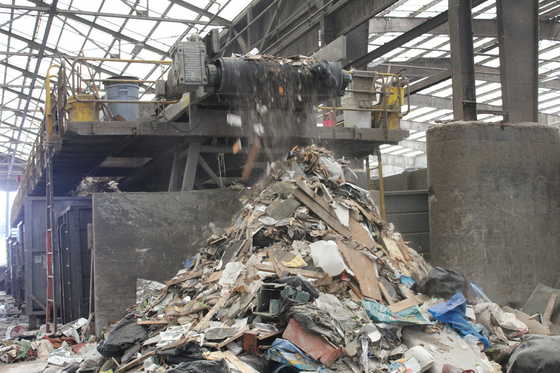 Unsalvageable dry waste drops off the end of the line where it has been picked through and sorted by Recology employees.