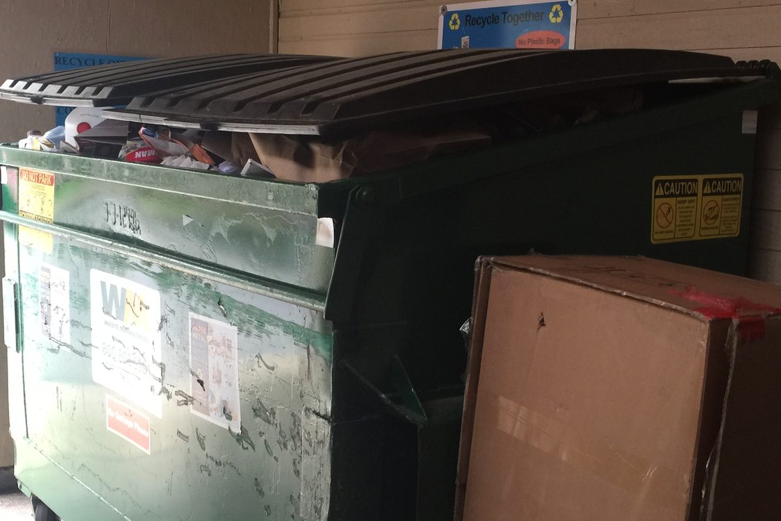 dumpster is so full the lids cannot close