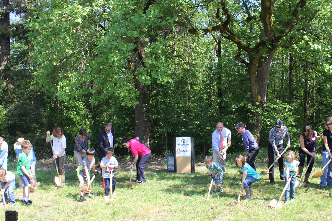 Hillsboro and Metro officials and seven Orenco Elementary School students break ground at Orenco Woods.