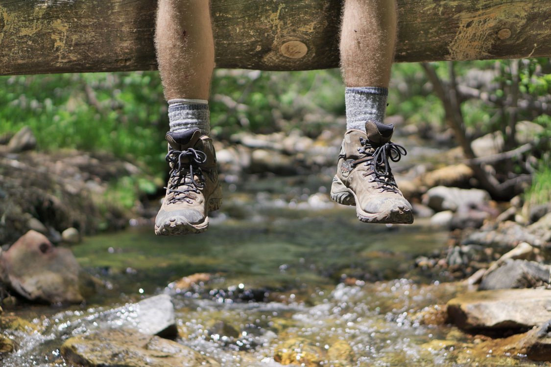 photo of feet dangling from log