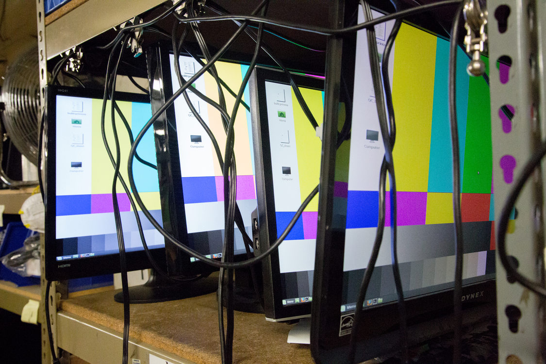 donated computer monitors being tested on a testing bench