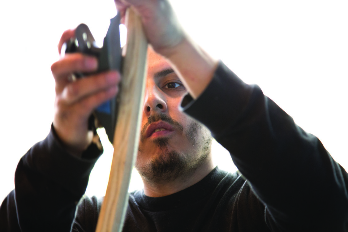 photo of Josh Bruno making a traditional digging stick