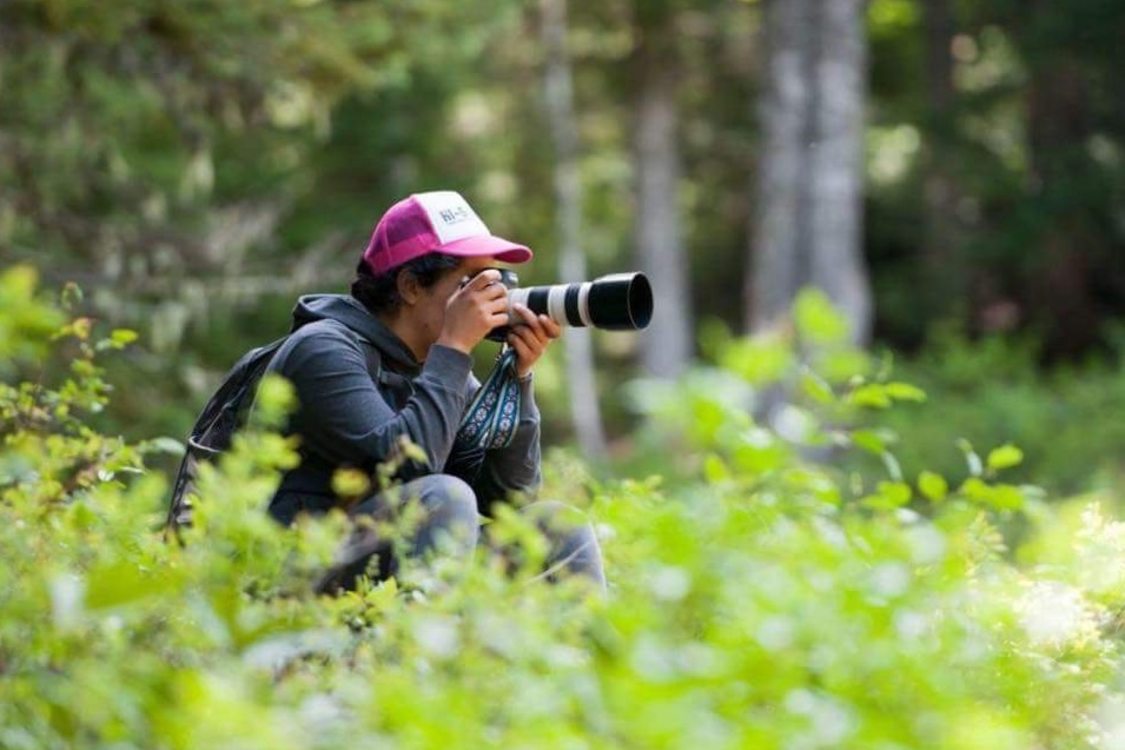 Nature photographer taking photos in a forested location