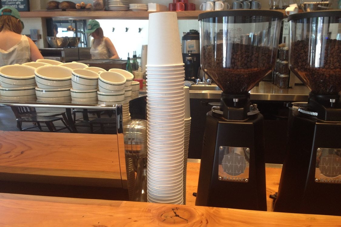 Stack of paper coffee cups at a cafe