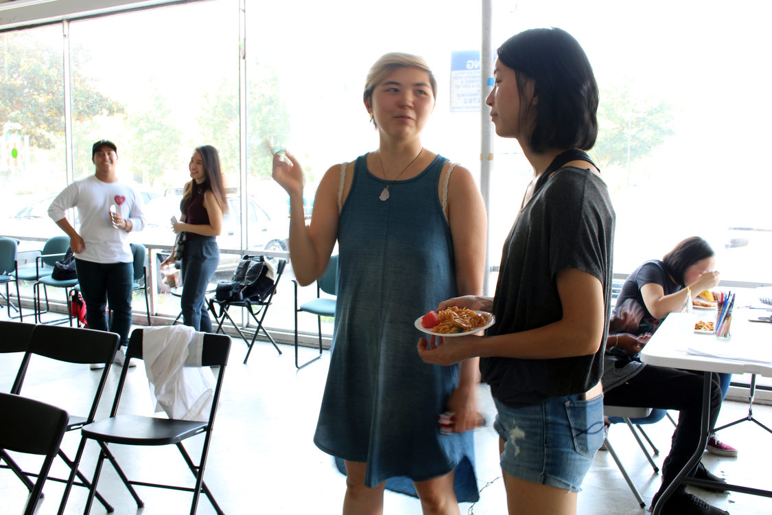 APANO's Candace Kita and OPAL's Jennifer Phung at a community meeting