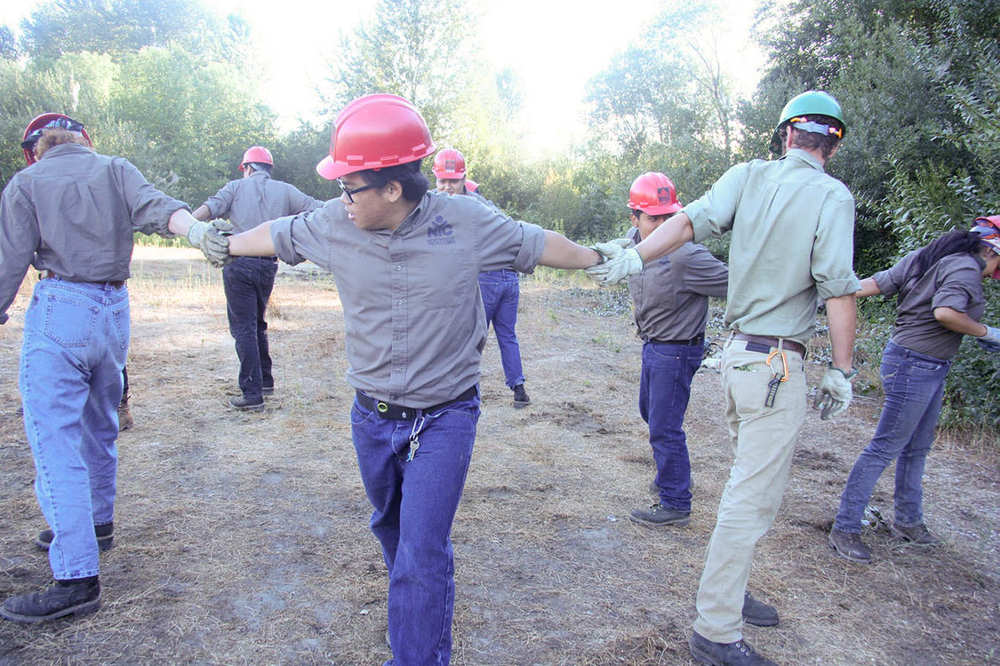 work crew engaging in team-building exercise together