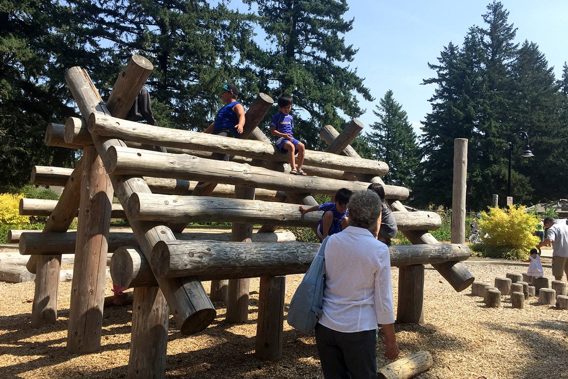 Children on the climbing structure in the nature-based playground at Gresham's Nadaka Nature Park