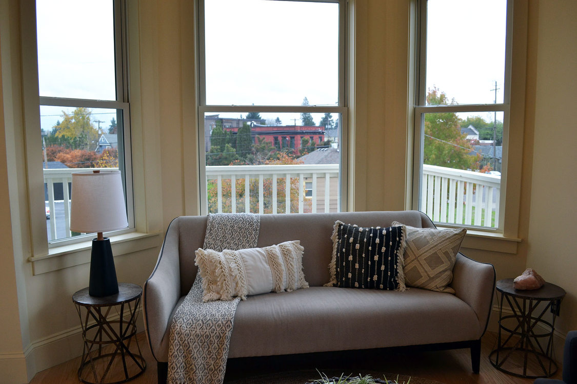 Portrait of a living room with big windows in the background