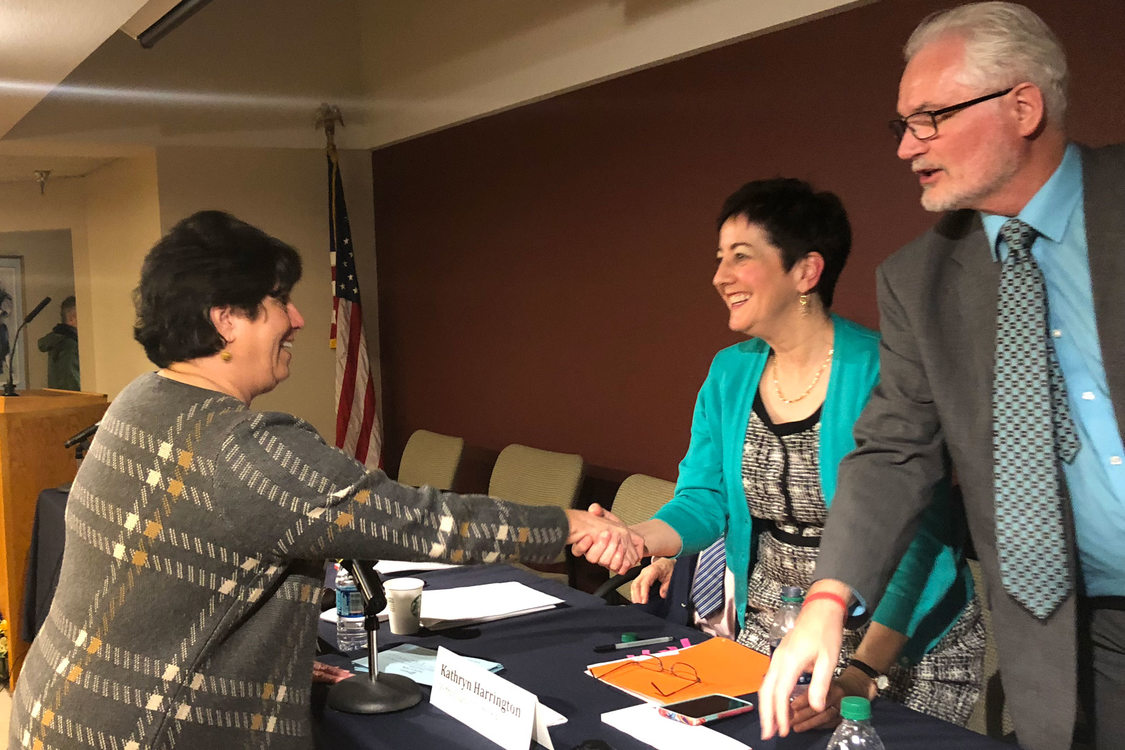 Betty Dominguez shaking hands with Metro councilors Kathryn Harrington and Craig Dirksen