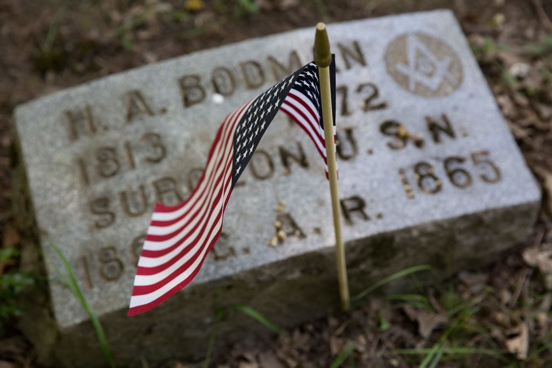 American flag placed at grave on Memorial Day