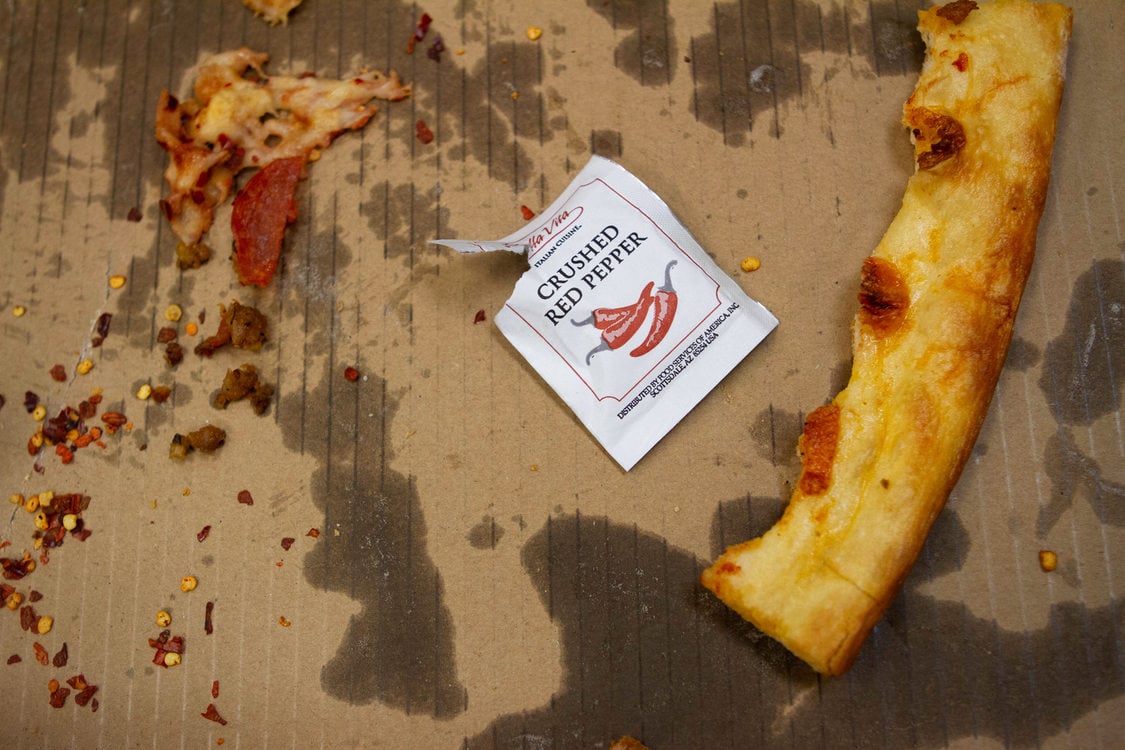 image of a used greasy cardboard pizza box