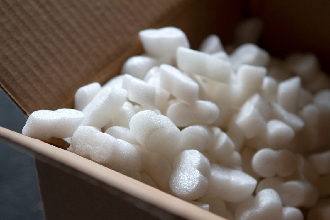 styrofoam packing peanuts inside a cardboard packing box