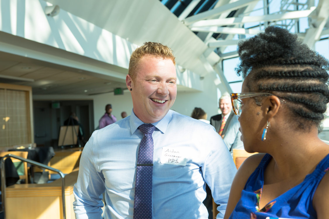 Photo of people chatting at a reception