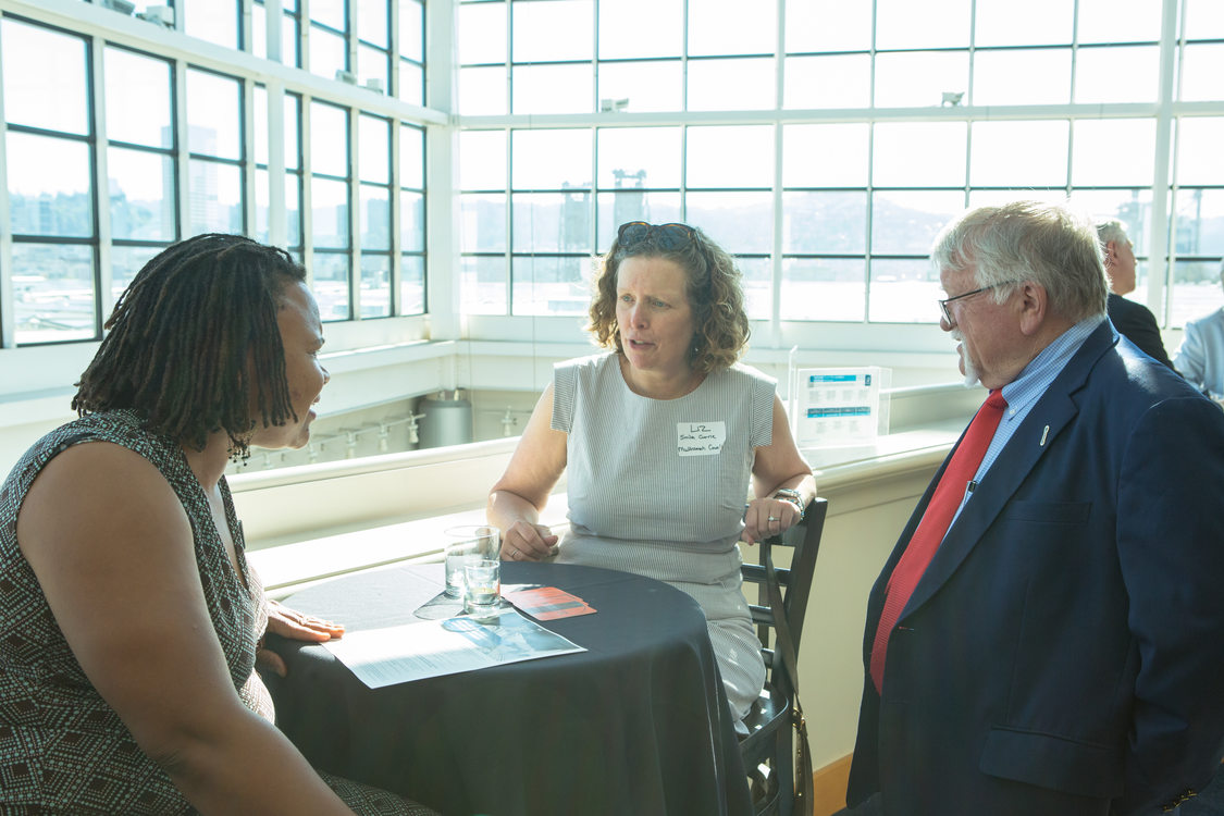 Photo of people chatting at a reception