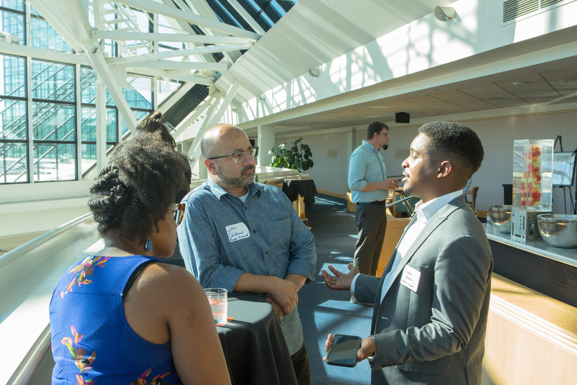 Photo of people chatting at a reception