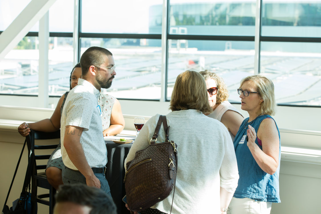 Photo of people chatting at a reception