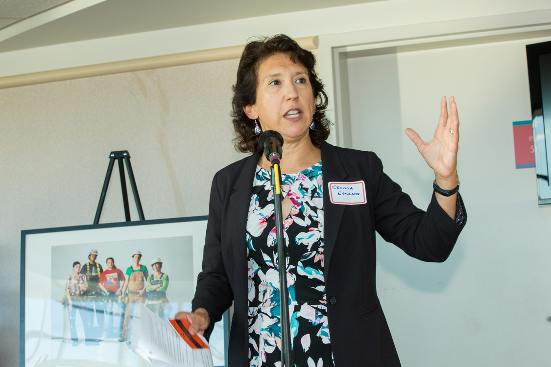 Photo of woman speaking at microphone