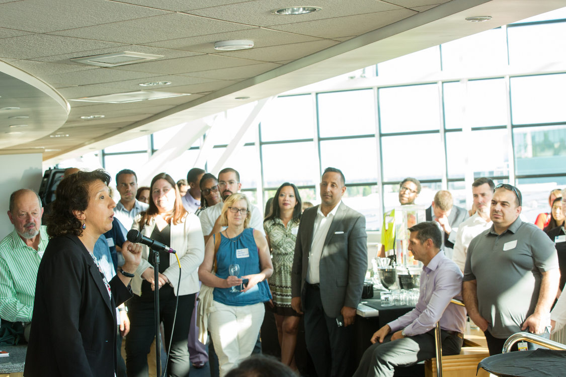 Photo of woman speaking to room of people