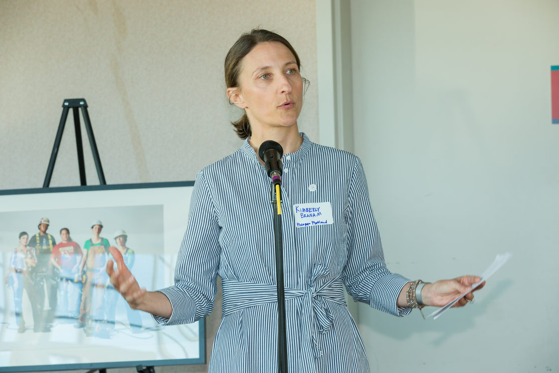 Photo of woman speaking at microphone