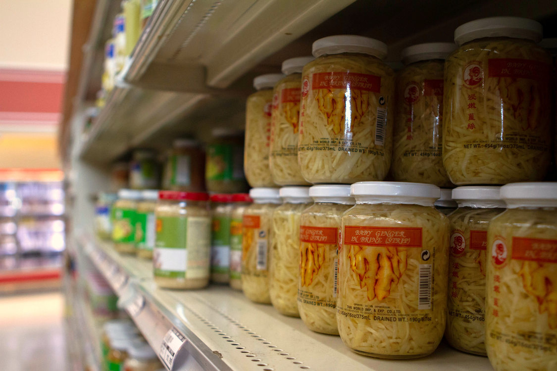 glass jars of ginger sit on grocery store shelves